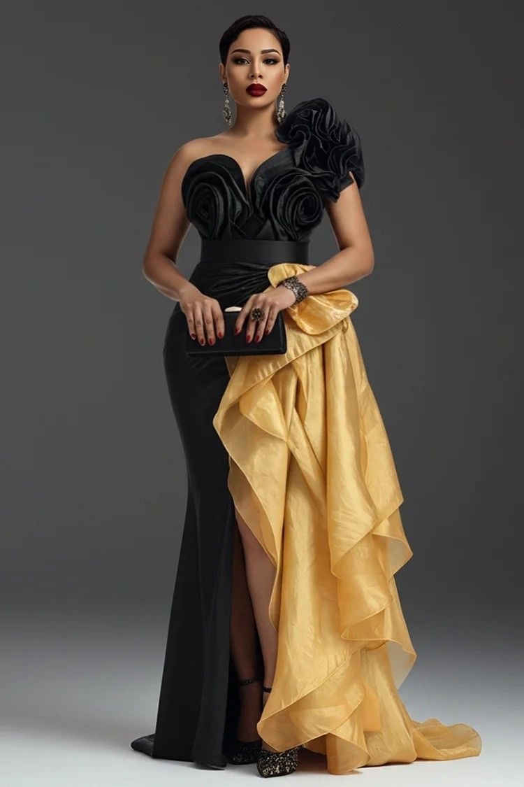 Woman in elegant black strapless gown with rose appliques and flowing gold fabric drape, wearing red lipstick and statement jewelry